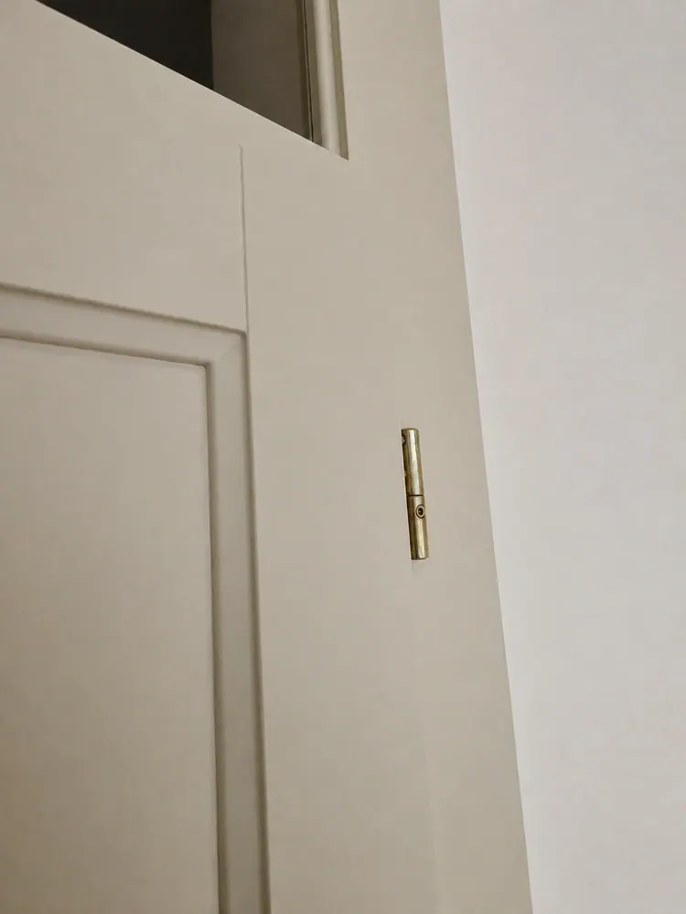 Bílé interiérové dveře s bronzovým zámkem